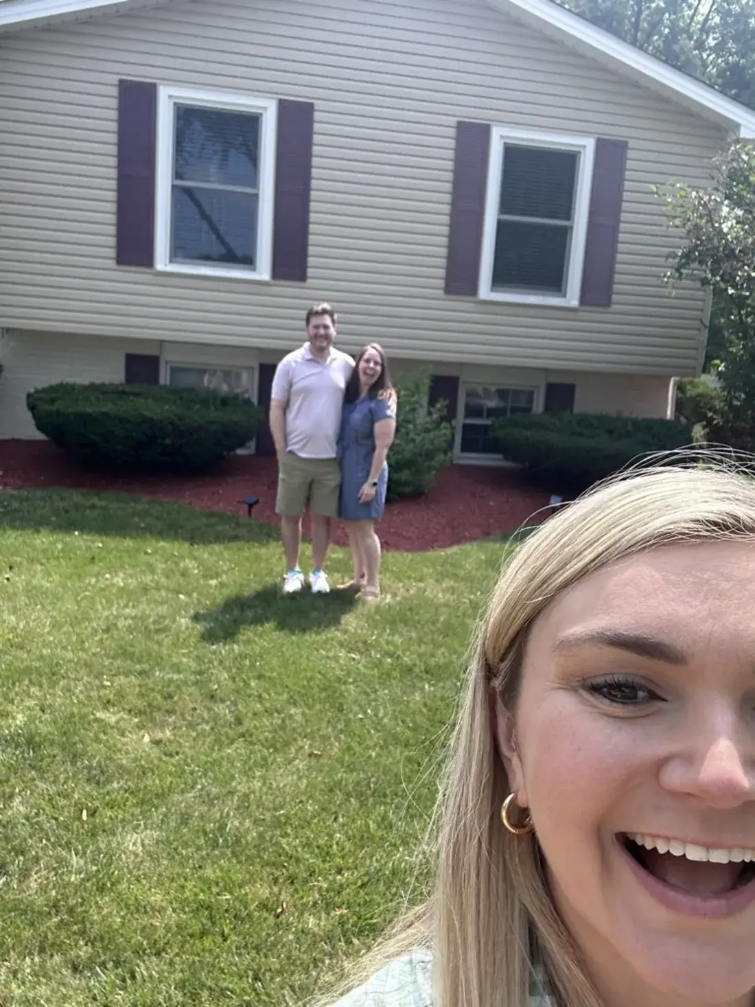Moe Hannon with clients outside the home they just bought